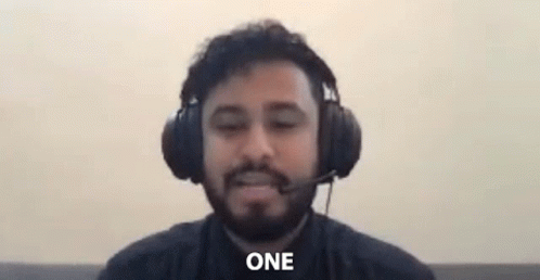 Bearded Man with Headphones and Microphone Saying One