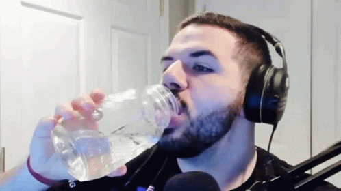 Bearded Man With Headphones Drinking Water