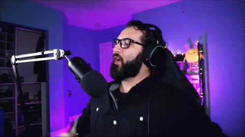 Bearded Man With Headphones Glasses at Microphone