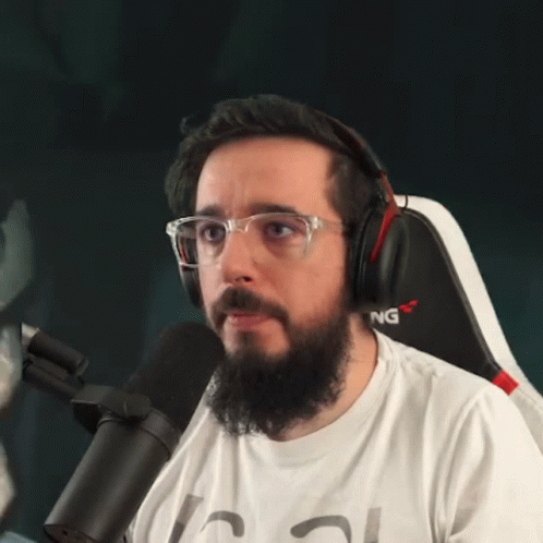 Bearded Man With Headphones Glasses in Gaming Chair