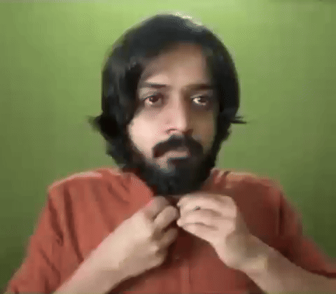 Bearded Man With Long Hair Adjusting Shirt