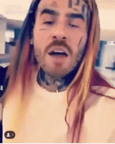 Bearded Man With Long Hair and Face Tattoo