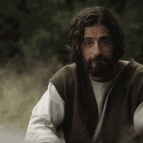 Bearded Man With Long Hair in Vest and White Shirt