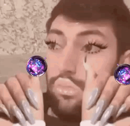 Bearded Man With Long Nails and Earrings