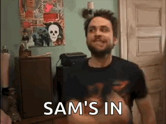 Bearded Man With Sam's In On Shirt GIF