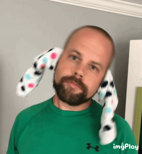 Bearded Man With Stuffed Animal on Head in Green Under Armour