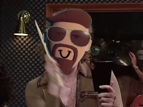 Bearded Man With Sunglasses Holding Letter U in Mouth