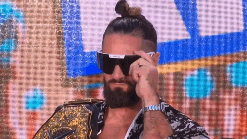 Bearded Man With Sunglasses Holding Wrestling Belt