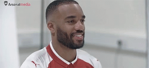 Bearded Soccer Player Smiling In Red And White Jersey GIF
