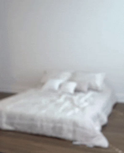 Bed With White Sheets and Pillows