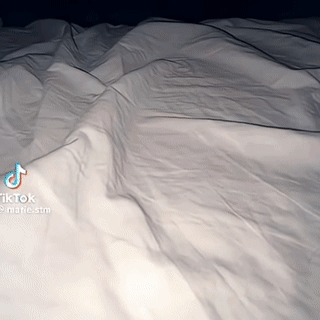 Bed With White Sheets and TikTok Watermark