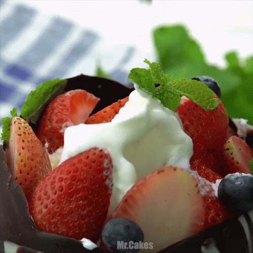 Berries And Cream Topped With Mint Leaves GIF