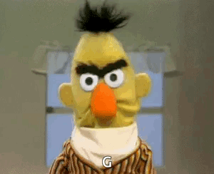 Bert From Sesame Street Is Angry And Says `` G '' While Standing In Front Of A Window . GIF