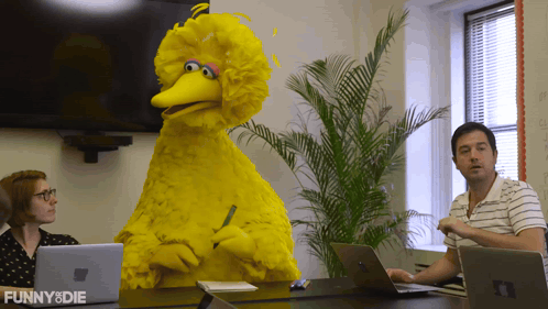 Big Bird From Sesame Street Sits At A Table With A Man And Woman GIF
