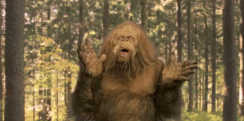 Bigfoot Standing in Forest with Mouth Open