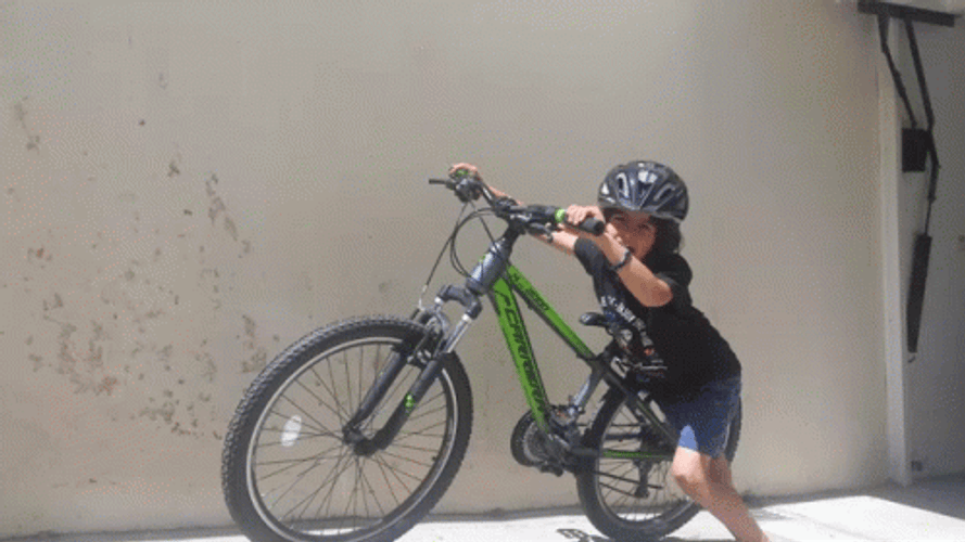 Bike Riding Kid Assisting The Bike GIF