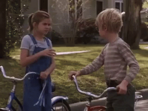 Biking Little Boy And Girl Shaking Hands GIF