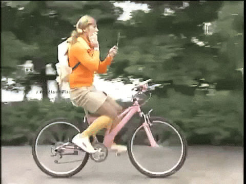 Biking While Doing Some Make Up GIF