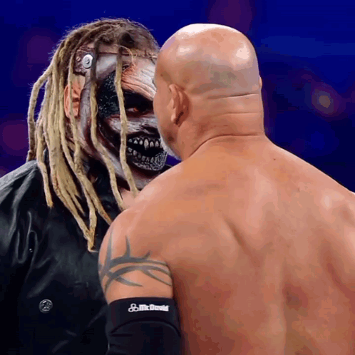 Bill Goldberg Roman Reigns Face Off GIF