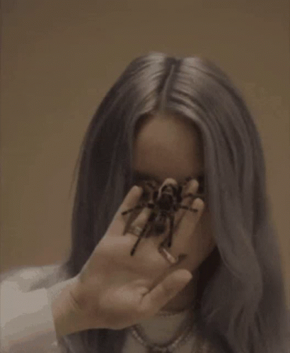 Billie Eilish Holding Spider in Front of Face
