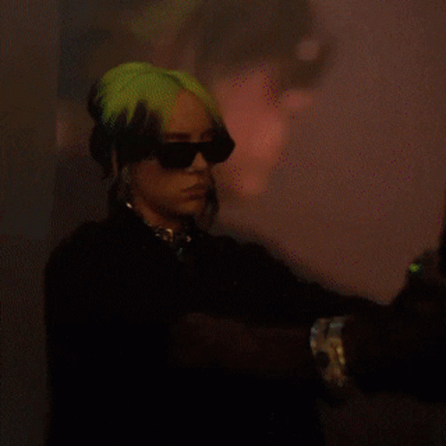 billie eilish is wearing sunglasses and gloves in a pixelated photo