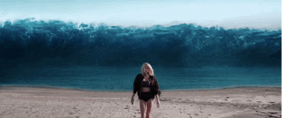 Billie Eilish Walking In Big Waves Background GIF