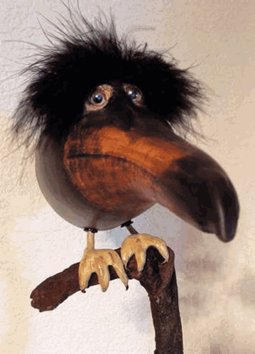 Bird Statue With Long Beak On Branch GIF