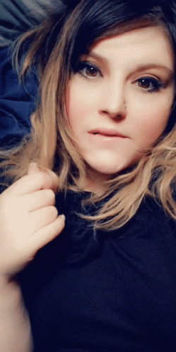 Playful Girl Biting Lip Twirling Hair GIF