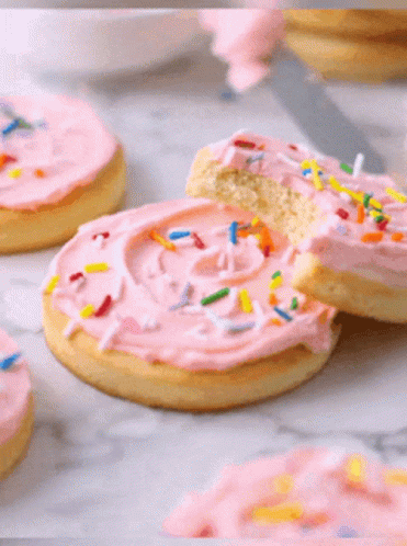Bitten Cookie With Pink Frosting and Sprinkles
