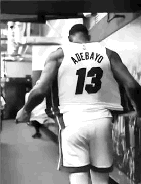 Black and White Basketball Player Walking in Locker Room