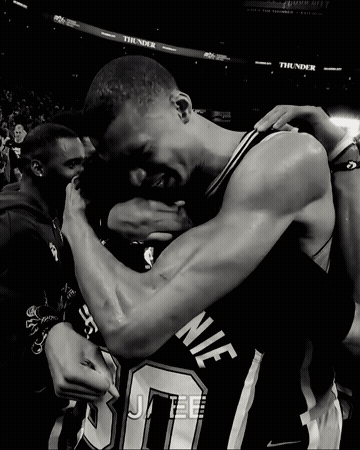 Black And White Basketball Players Hugging Number 10 GIF