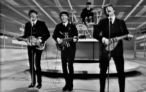 Black And White Beatles Performing On Stage GIF