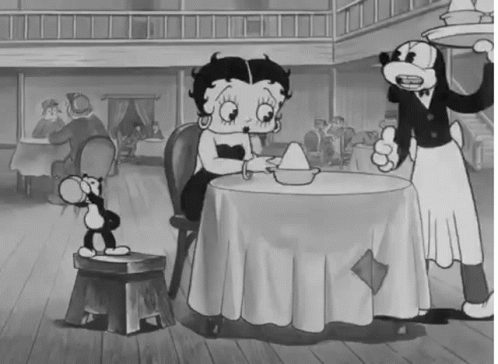 Black and White Betty Boop Sitting at Restaurant Table