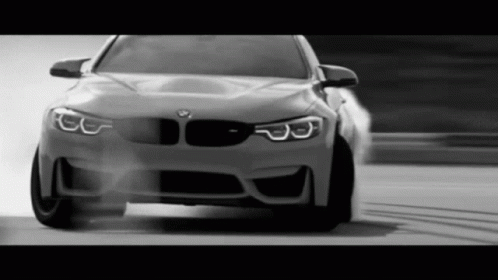 Black and White BMW Driving on Road