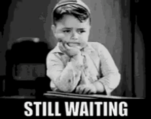 Black and White Boy Sitting at Desk Still Waiting