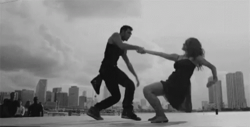 Black and White Couple Dancing on Rooftop