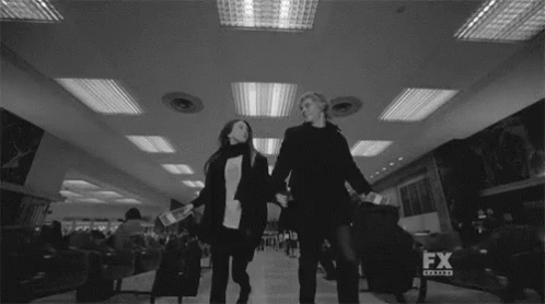 Black and White Couple Holding Hands at Airport