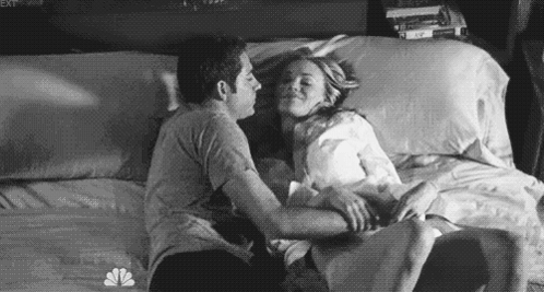 Black And White Couple On Bed Snuggles GIF