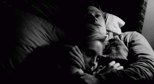Black And White Couple Snuggles On Bed GIF