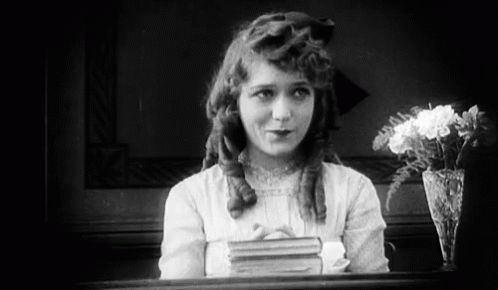 Black and White Girl with Book and Vase of Flowers