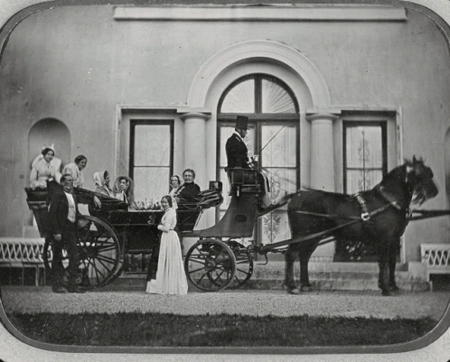 Black and White Horse Drawn Carriage With People