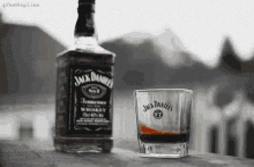 Black And White Jack Daniel's Bottle And Glass With Whiskey GIF