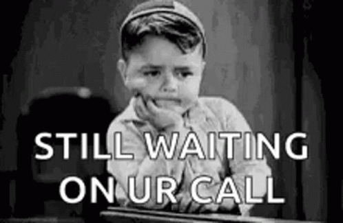 Black And White Little Boy Waiting For Call At Desk GIF