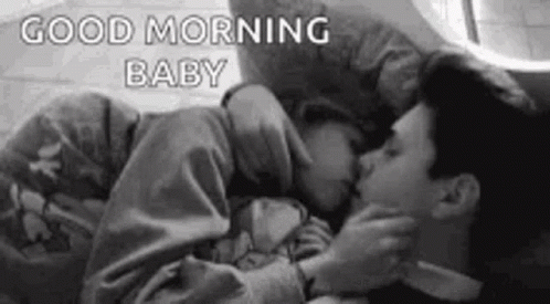 Black and White Man and Woman Kissing in Bed