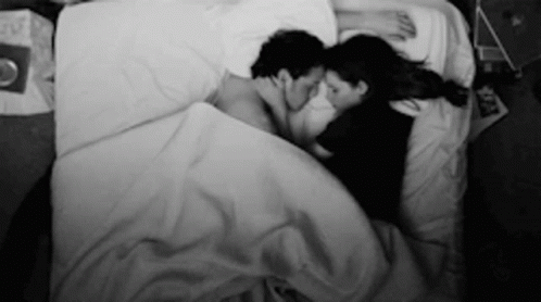 Black and White Man and Woman Lying in Bed