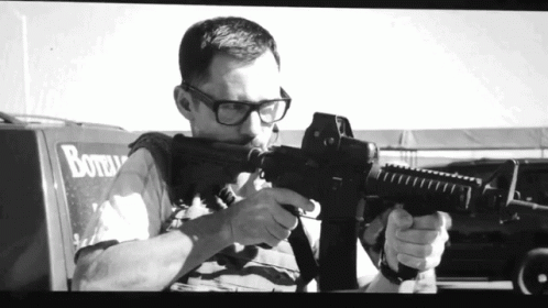 Black and White Man Holding Gun by Bottle Truck