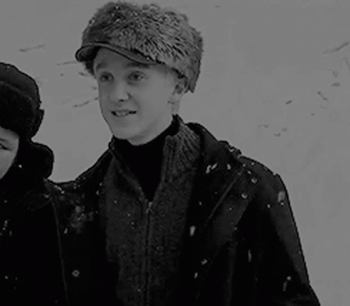 Black and White Man in Fur Hat with Woman in Snow