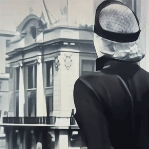 Black and White Man in Hat Looking at Building