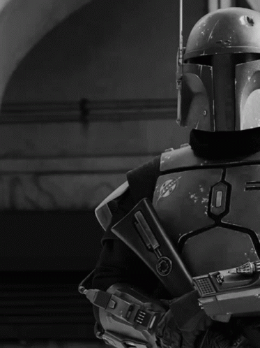 Black and White Man in Helmet Holding Gun