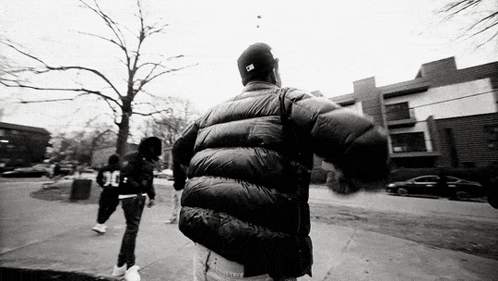 Black And White Man In Jacket Hat Walking GIF